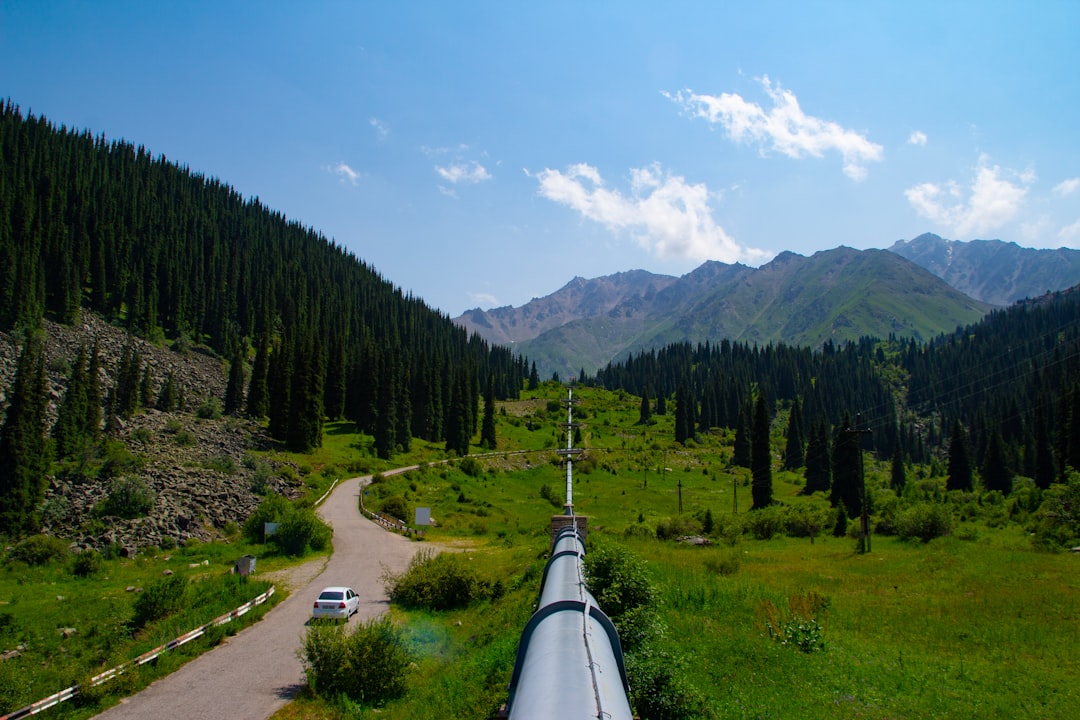 A pipeline running through a lush green valley, water infrastructure connecting communities across America